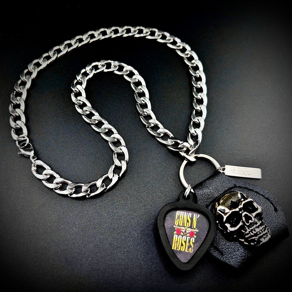 GUNS N' ROSES BULLET LOGO guitar pick pendant necklace with silver curb chain and skull holder by SKULL & CHAIN. For fans of Slash and Axl Rose.