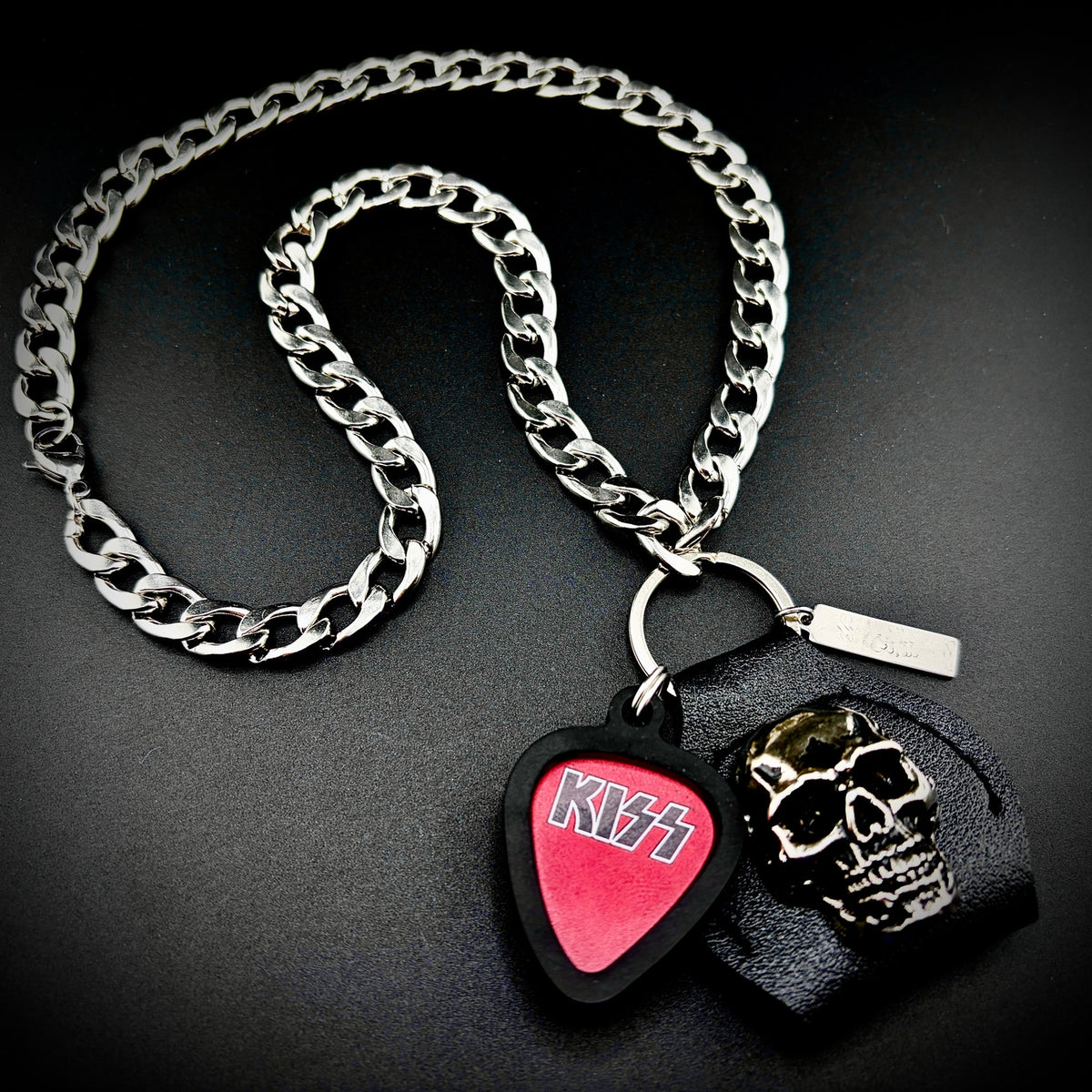 KISS Red Black Logo Guitar Pick Pendant Necklace by SKULL & CHAIN. For fans of Paul Stanley, Gene Simmons, Ace Frehley and Peter Criss.
