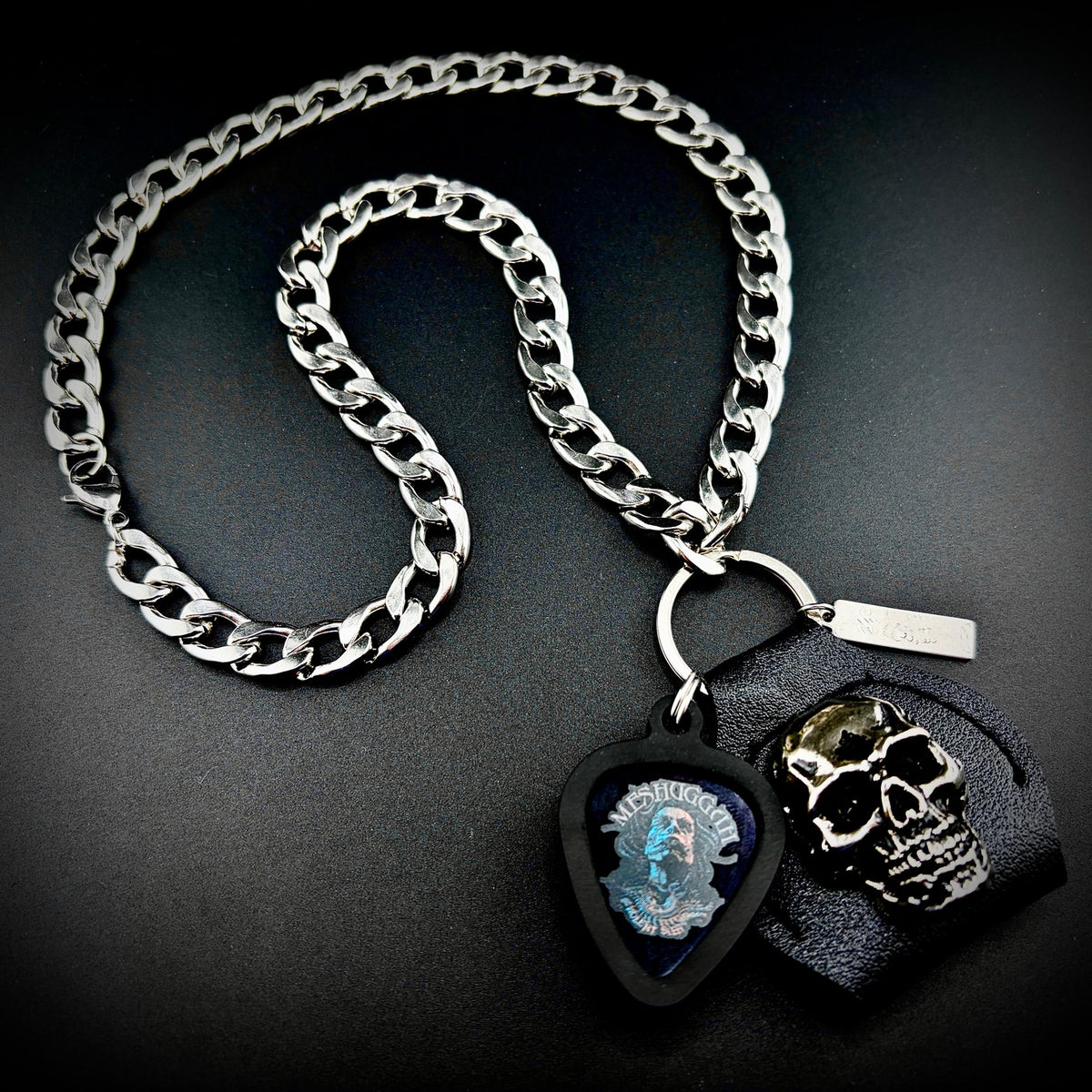 Meshuggah The Violent Sleep of Reason guitar pick pendant necklace with SKULL & CHAIN skull and stainless curb chain. For fans of Jens Kidman, Fredrik Thordendal and Mårten Hagström.